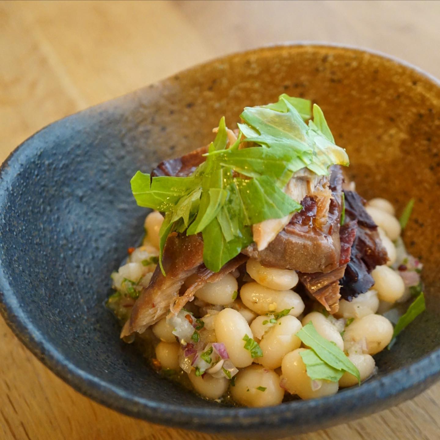 さて、先週に引き続きまして「自家製ツナと白いんげん豆の冷菜」お出ししております。でもあんまり人気ないのよね…店長ミヤザキは豆が好きなので大好きなんですが。自家製ツナにはにんにくレモンドレッシングをちょいがけで。豆の部分はシンプルなフレンチドレッシングでマリネしております。これで白ワインとか飲みたいなあ。
そして牛タン！今回は塩煮込みでご用意しました。牛タンで取れたスープと大根の甘みを活かしたシンプルな味付けです。ご飯と一緒に食べるとクッパ風になるかもです。
ではでは、今週もよろしくお願いします！（麻）